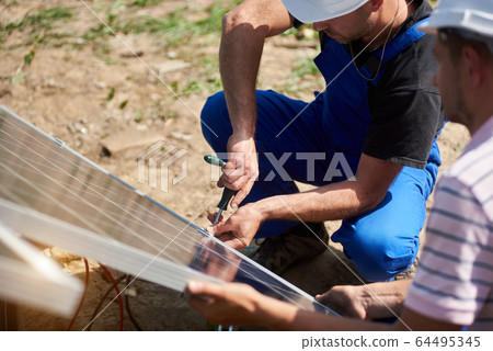 Stand-alone exterior solar panel system installation, renewable green energy generation concept. Stand-alone exterior solar panel system installation, renewable green energy generation concept. 64495345
