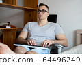 The quarantined guy works remotely from home. Communication, people and freelance work concept 64496249
