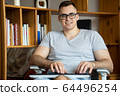 The quarantined guy works remotely from home. Communication, people and freelance work concept 64496254