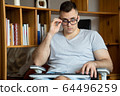 The quarantined guy works remotely from home. Communication, people and freelance work concept 64496259