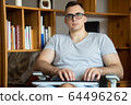 The quarantined guy works remotely from home. Communication, people and freelance work concept 64496262
