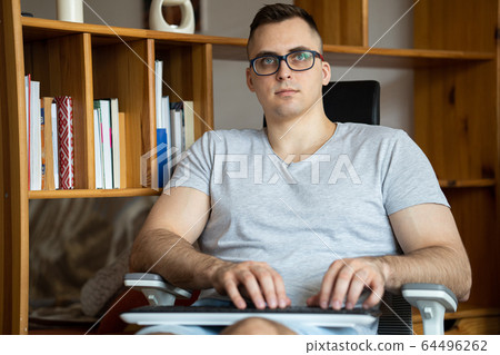 The quarantined guy works remotely from home. Communication, people and freelance work concept 64496262