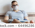The quarantined guy works remotely from home. Communication, people and freelance work concept 64496286