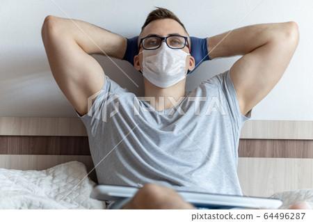 The quarantined guy works remotely from home. Communication, people and freelance work concept The quarantined guy works remotely from home. Communication, people and freelance work concept 64496287