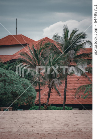 Beach views of the cliffs, splashing waves and traditional fishing boats on the shore. Beach views of the cliffs, splashing waves and traditional fishing boats on the shore. 64498711