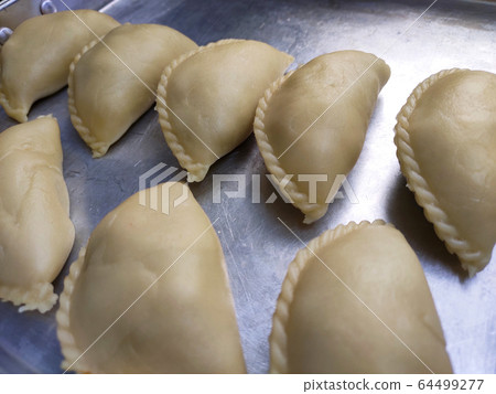 Curry puffs for sale. It is one of the traditional cakes in Malaysia. Skin made from the wheat flour mixture and the inside is potato and curry mixture. Curry puffs for sale. It is one of the traditional cakes in Malaysia. Skin made from the wheat flour mixture and the inside is potato and curry mixture. 64499277