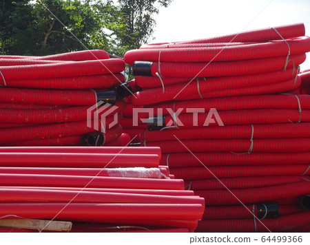 HDPE corrugated pipe with double-wall strength at the construction site. Used to protect underground cable. 64499366