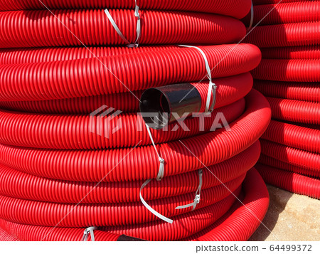 HDPE corrugated pipe with double-wall strength at the construction site. Used to protect underground cable. 64499372