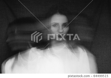 crazy portrait of girl with mental disorders and split personality. Black and white with added grain and motion blur crazy portrait of girl with mental disorders and split personality. Black and white with added grain and motion blur 64499515