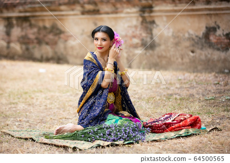 Indonesia Young beautiful woman with Traditional dress standing and look at camera at Gate to heaven Handara Golf Gate in Bedugul, Bali ,Indonesia. Indonesia Young beautiful woman with Traditional dress standing and look at camera at Gate to heaven Handara Golf Gate in Bedugul, Bali ,Indonesia. 64500565