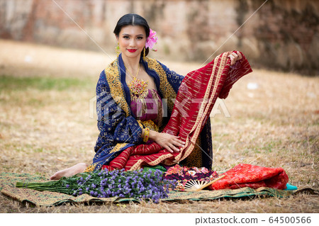 Indonesia Young beautiful woman with Traditional dress standing and look at camera at Gate to heaven Handara Golf Gate in Bedugul, Bali ,Indonesia. Indonesia Young beautiful woman with Traditional dress standing and look at camera at Gate to heaven Handara Golf Gate in Bedugul, Bali ,Indonesia. 64500566