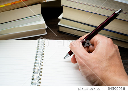 Learned Notepad and stacked books 64500936