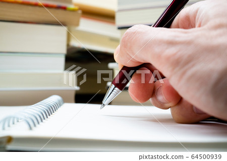 Learned Notepad and stacked books 64500939