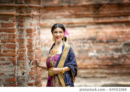 Indonesia Young beautiful woman with Traditional dress standing and look at camera at Gate to heaven Handara Golf Gate in Bedugul, Bali ,Indonesia. Indonesia Young beautiful woman with Traditional dress standing and look at camera at Gate to heaven Handara Golf Gate in Bedugul, Bali ,Indonesia. 64501066