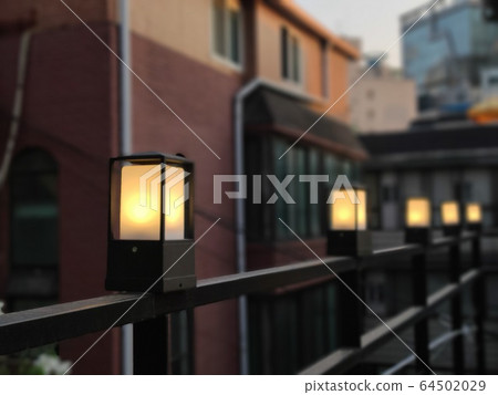 Lanterns, lights and street lights on rooftop railings 64502029