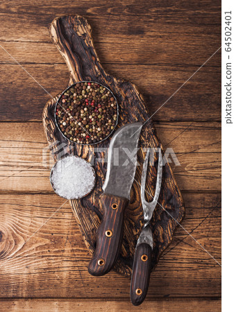 Vintage fork and knife for meat on wooden chopping 64502401