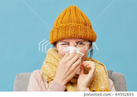 Sick woman in warm clothing 64502693
