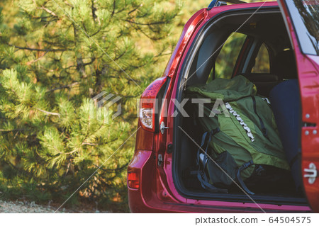 Touristic backpack in car back close up Touristic backpack in car back close up 64504575