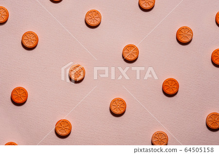 Pillslike an orange on a beige background. Vitamin Pillslike an orange on a beige background. Vitamin 64505158