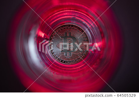 Cryptocurrency falling to the bottom. Red background and purple backlight. Cryptocurrency falling to the bottom. Red background and purple backlight. 64505329