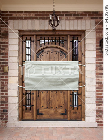 Medical Face Mask Covering Front Door of a House 64505798