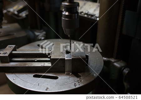 Drilling with a drilling machine Drilling with a drilling machine 64508521