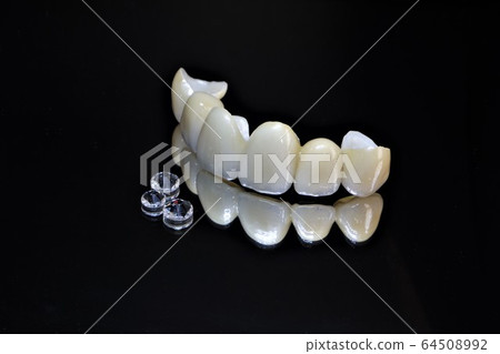 Have a beautiful white ceramic tooth by a dentist and welcome the new year with a smile Have a beautiful white ceramic tooth by a dentist and welcome the new year with a smile 64508992