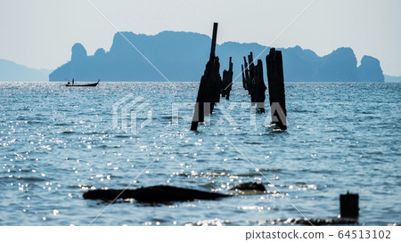 Fisherman on boat near ruin bridge, Krabi Fisherman on boat near ruin bridge, Krabi 64513102