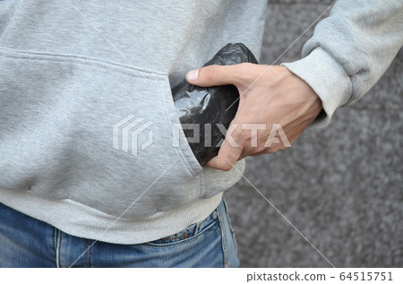 Drug dealer taking bag with cocaine out of hoodie 64515751