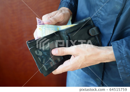 Close up male hands opened the wallet or purse Close up male hands opened the wallet or purse 64515759