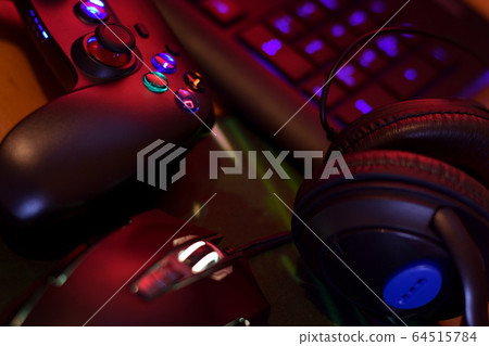Modern gamepad and gaming mouse lies with keyboard 64515784