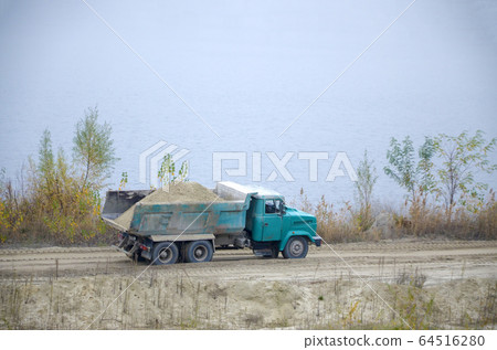 Dump truck transports sand and other minerals in Dump truck transports sand and other minerals in 64516280