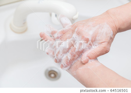 Senior woman washing hands 64516501