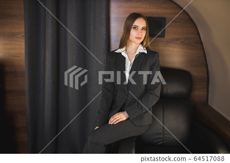 Attractive woman in private jet 64517088