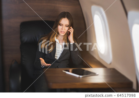 Attractive woman in private jet 64517098