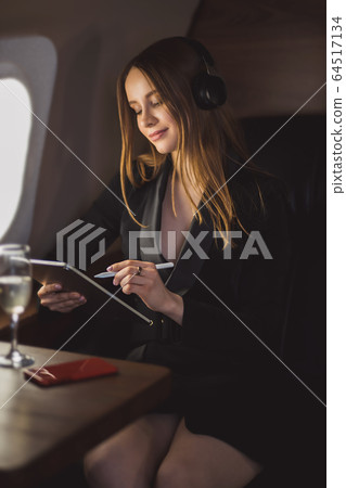 Attractive woman in private jet 64517134