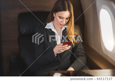 Attractive woman in private jet 64517137