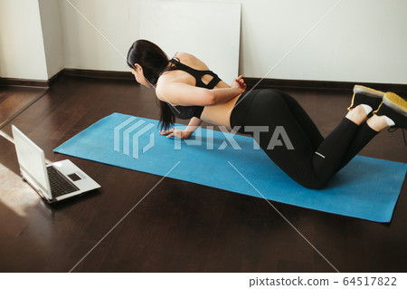 woman doing sport exercise using online guide woman doing sport exercise using online guide 64517822