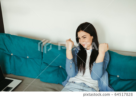 Young excited lady in living room 64517828