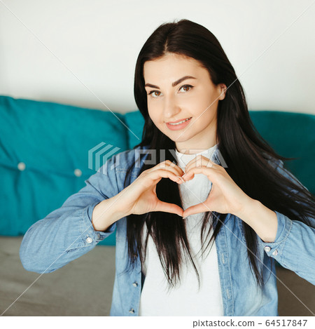 woman making heart shape with hands woman making heart shape with hands 64517847