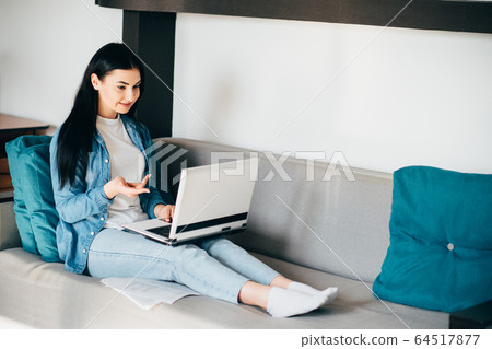 Young woman speaking while video conference call Young woman speaking while video conference call 64517877