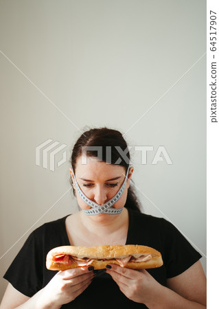 Obese woman with unhealthy food, eating disorder 64517907