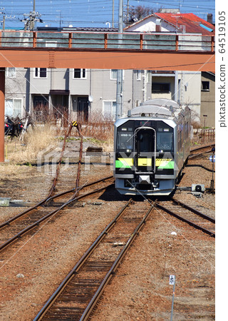 We photograph scenery of ordinary train departing and arriving at JR Yoichi station in spring Hokkaido 64519105