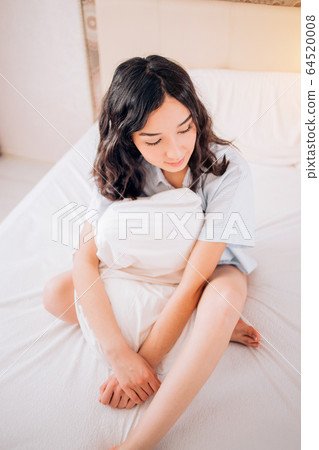 Young beautiful woman sleeping in bed, relaxing in Young beautiful woman sleeping in bed, relaxing in 64520008