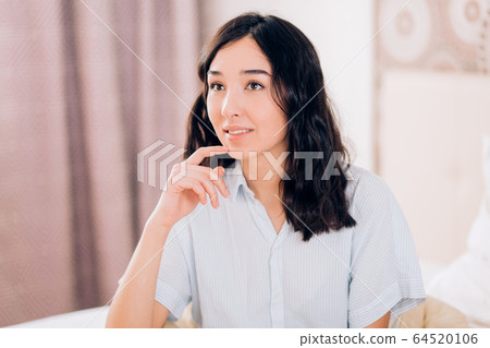 Beautiful Positive woman sitting in bed in morning Beautiful Positive woman sitting in bed in morning 64520106