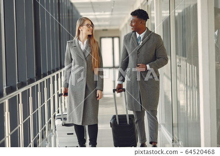 Elegant black man at the airport with his businesspartner 64520468
