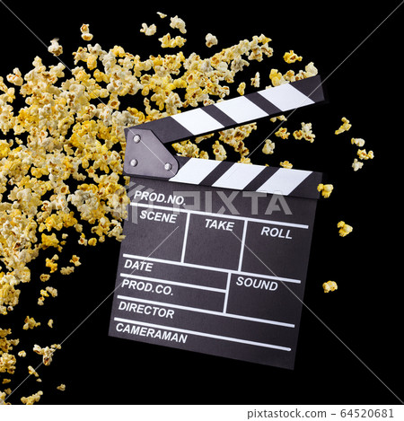 Flying popcorn and film clapper board isolated on black background 64520681