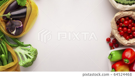 Garden fresh vegetables in eco friendly bags on white 64524468