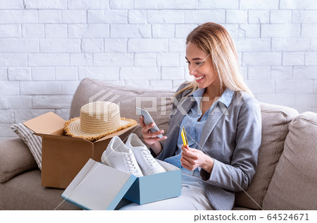 Happy girl received delivery an online purchase Happy girl received delivery an online purchase 64524671
