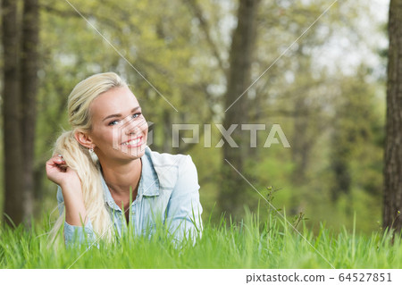 woman on the green grass 64527851